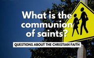 "What is the communion of saints?" over crosswalk sign