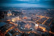 Saint Peter Square at night with lights on the street turned on