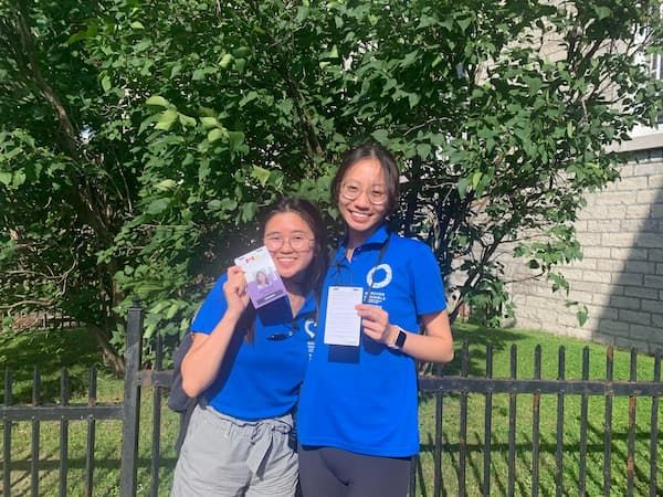 Aubrey and Tina showing their participant badges
