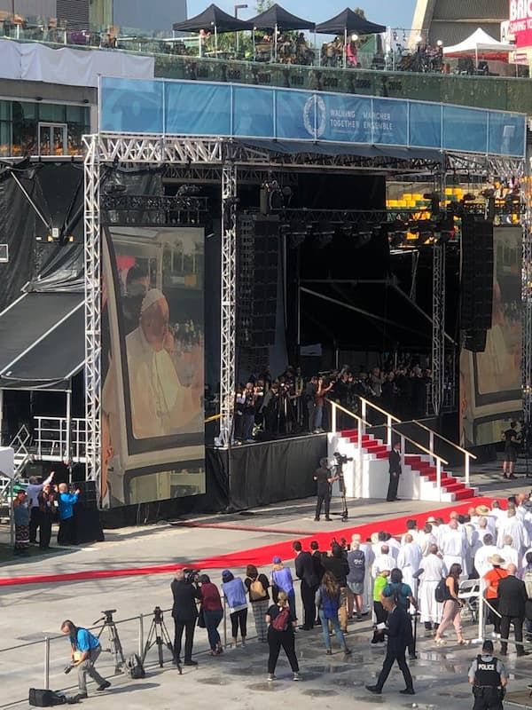 Stage full of photographers taking pictures of Pope Francis in the papamobile.