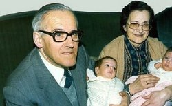 Laura and Eduardo with their children and grandchildren in a living room