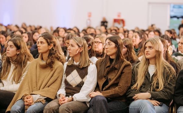 Close up of a group of girls listening to the Father