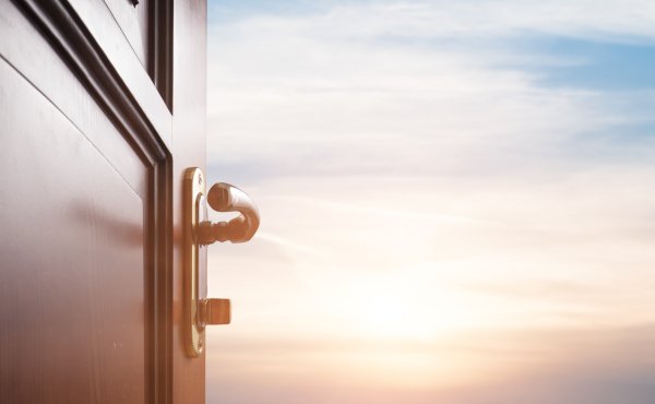 Offene Tür ins Freie zur Sonne am Horizont