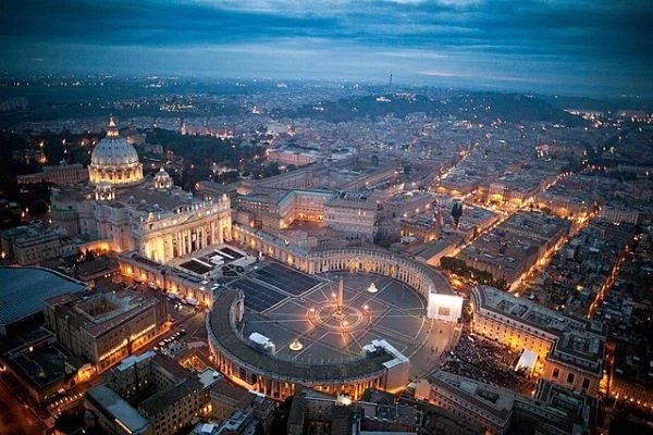 Saint Peter Square at night with lights on the street turned on