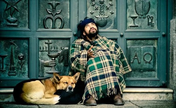 a beggar in front of a church